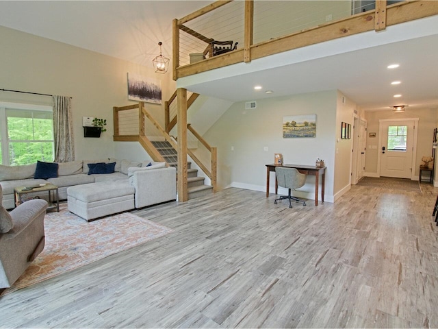 1585 Amidon Rd Unit 1, 2, 3, Montgomery, VT 05471 - living area with a towering ceiling, stairs, wood finished floors, baseboards, and recessed lighting
