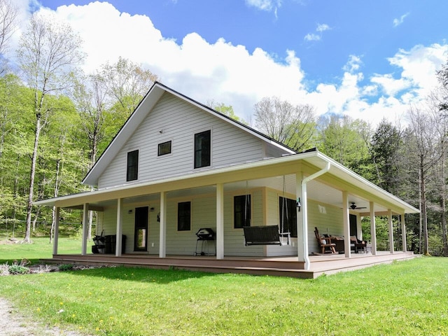 1585 Amidon Rd Unit 1, 2, 3, Montgomery, VT 05471 - back of house with covered porch, a lawn, and ceiling fan