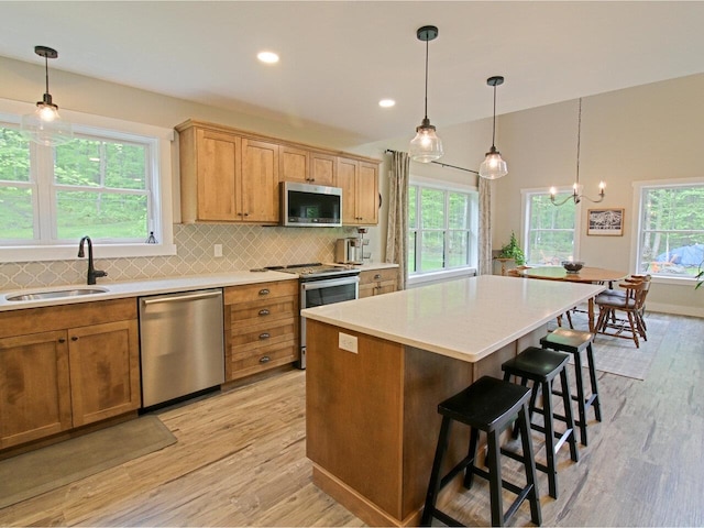 1585 Amidon Rd Unit 1, 2, 3, Montgomery, VT 05471 - kitchen with stainless steel appliances, a sink, light wood finished floors, backsplash, and recessed lighting