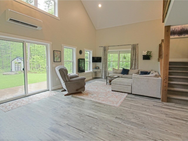 1585 Amidon Rd Unit 1, 2, 3, Montgomery, VT 05471 - living area with a wall mounted air conditioner, high vaulted ceiling, plenty of natural light, wood finished floors, and stairs