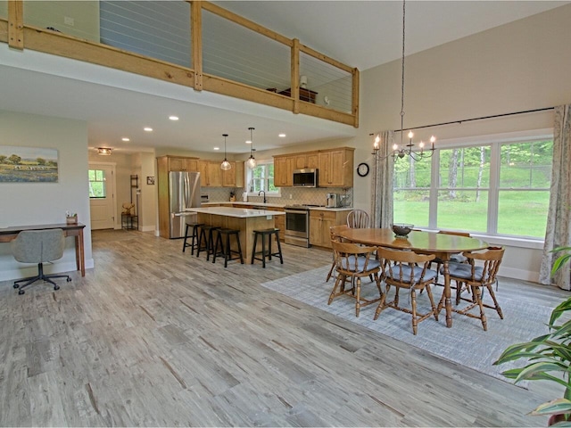 1585 Amidon Rd Unit 1, 2, 3, Montgomery, VT 05471 - dining space featuring a towering ceiling, a chandelier, recessed lighting, light wood-style flooring, and baseboards