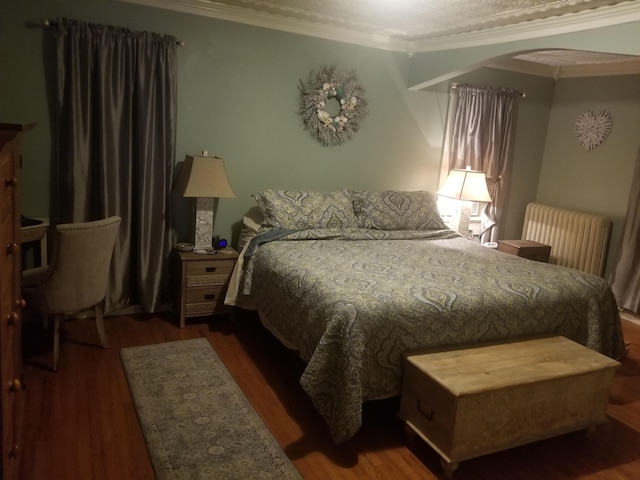 22 Chestnut St, Claremont, NH 03743 - bedroom featuring ornamental molding, wood finished floors, radiator heating unit, and arched walkways
