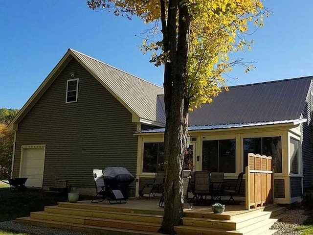 22 Chestnut St, Claremont, NH 03743 - back of property with a wooden deck and metal roof
