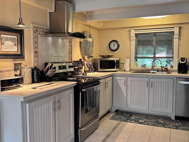 22 Chestnut St, Claremont, NH 03743 - kitchen featuring appliances with stainless steel finishes, wall chimney range hood, a sink, light tile patterned floors, and light countertops