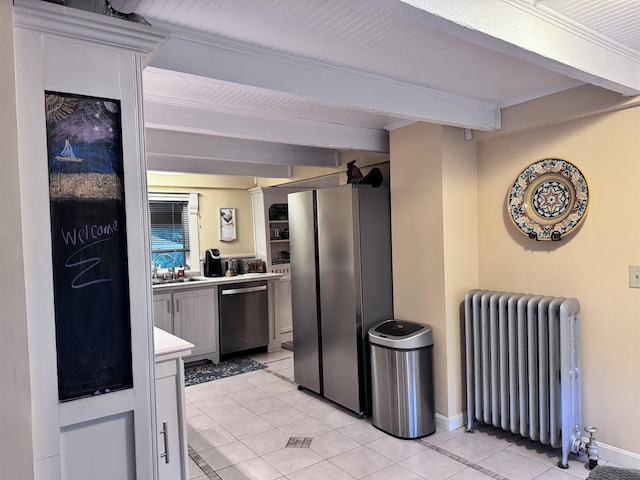 22 Chestnut St, Claremont, NH 03743 - kitchen with radiator heating unit, appliances with stainless steel finishes, light tile patterned floors, beamed ceiling, and light countertops