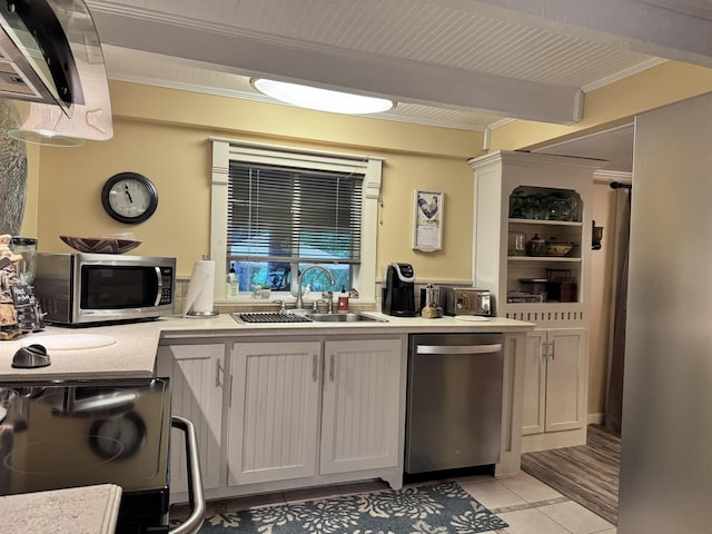 22 Chestnut St, Claremont, NH 03743 - kitchen featuring appliances with stainless steel finishes, a sink, light tile patterned flooring, ornamental molding, and beamed ceiling