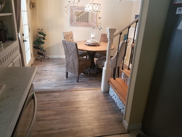 22 Chestnut St, Claremont, NH 03743 - dining room featuring baseboards, wood finished floors, and a chandelier