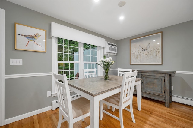 26 Eastwood Way, Manchester, NH 03109 - dining space featuring light wood-style floors, a wall mounted air conditioner, baseboards, and a baseboard heating unit