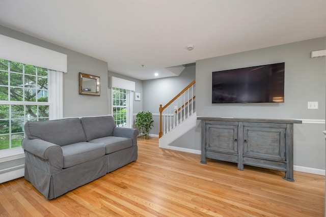 26 Eastwood Way, Manchester, NH 03109 - living room featuring wood finished floors, stairway, baseboards, and healthy amount of natural light