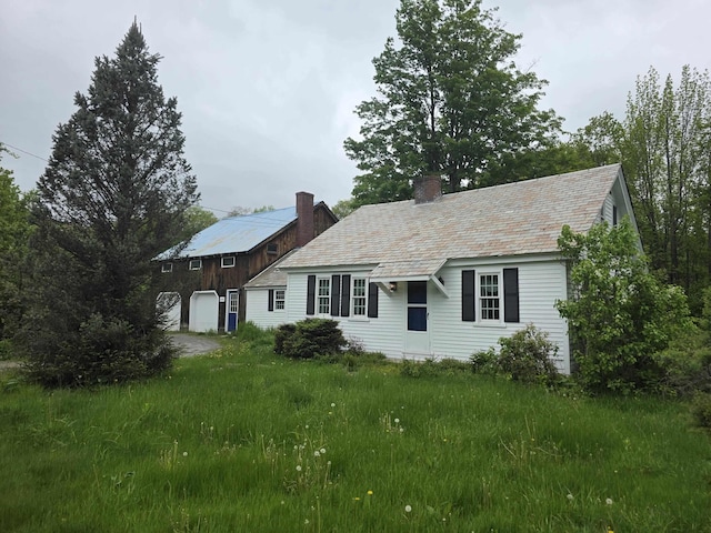 3458 Vt Route 30, Jamaica, VT 05343 - cape cod house with a chimney, a high end roof, and a garage
