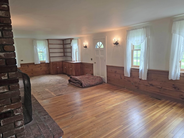 3458 Vt Route 30, Jamaica, VT 05343 - living room with hardwood / wood-style floors, wainscoting, and wood walls