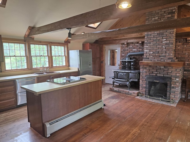 3458 Vt Route 30, Jamaica, VT 05343 - kitchen featuring stainless steel appliances, a sink, a baseboard radiator, light wood-type flooring, and light countertops