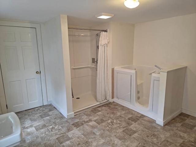 3458 Vt Route 30, Jamaica, VT 05343 - full bathroom featuring a shower stall, baseboards, and a bath