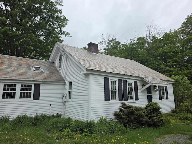 3458 Vt Route 30, Jamaica, VT 05343 - view of side of home with a chimney and a high end roof
