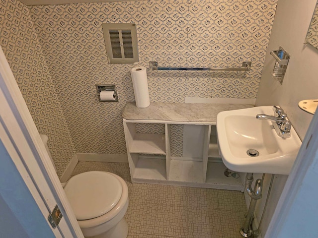 3458 Vt Route 30, Jamaica, VT 05343 - bathroom with a sink, toilet, and wallpapered walls