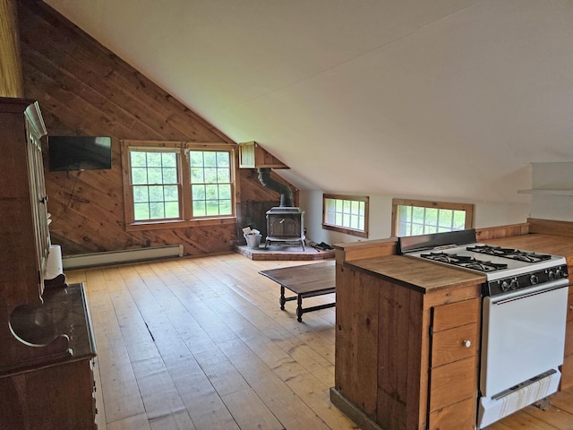 3458 Vt Route 30, Jamaica, VT 05343 - kitchen with white gas range oven, a wood stove, vaulted ceiling, light wood-style flooring, and a baseboard heating unit