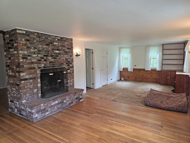3458 Vt Route 30, Jamaica, VT 05343 - unfurnished living room with wood-type flooring and a brick fireplace