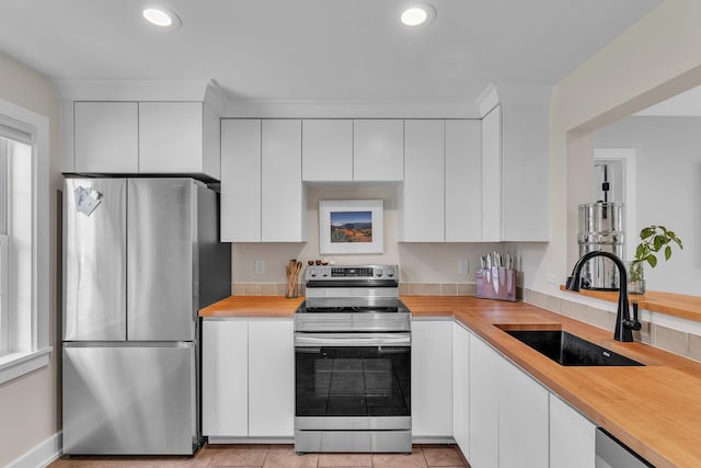 9 Conifer Ct, Burlington, VT 05401 - kitchen featuring appliances with stainless steel finishes, a sink, white cabinetry, and recessed lighting