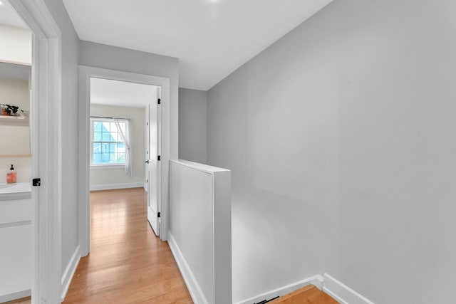 9 Conifer Ct, Burlington, VT 05401 - hallway featuring light wood finished floors, baseboards, and an upstairs landing