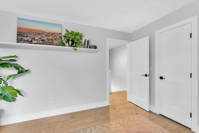 9 Conifer Ct, Burlington, VT 05401 - spare room featuring light wood-style floors, a smoke detector, and baseboards