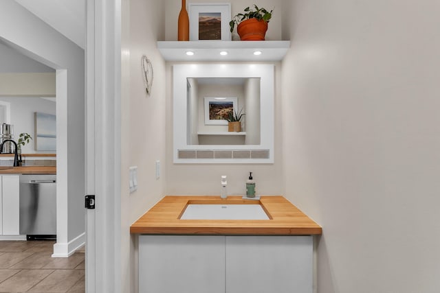 9 Conifer Ct, Burlington, VT 05401 - bathroom with a sink, baseboards, and tile patterned flooring