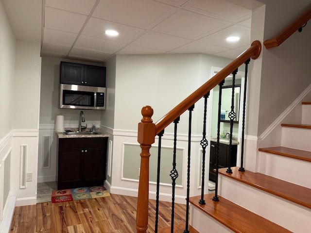 4 Sunblaze Dr, Nashua, NH 03062 - indoor wet bar featuring stainless steel microwave, light wood-style flooring, a wainscoted wall, stairway, and recessed lighting