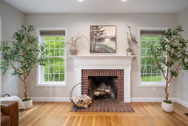 30 Mill Stone Ter, Bedford, NH 03110 - living area featuring a brick fireplace, wood finished floors, baseboards, healthy amount of natural light, and recessed lighting