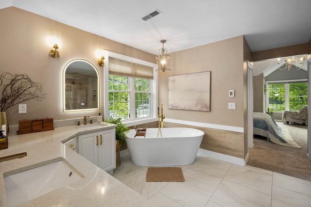 30 Mill Stone Ter, Bedford, NH 03110 - ensuite bathroom with vanity, a freestanding tub, a chandelier, and marble look tiles