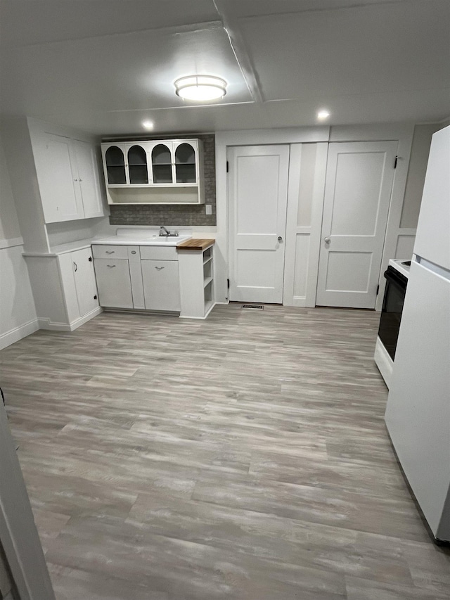 10 Deering Center Rd, Deering, NH 03244 - kitchen with freestanding refrigerator, light countertops, stove, light wood finished floors, and open shelves