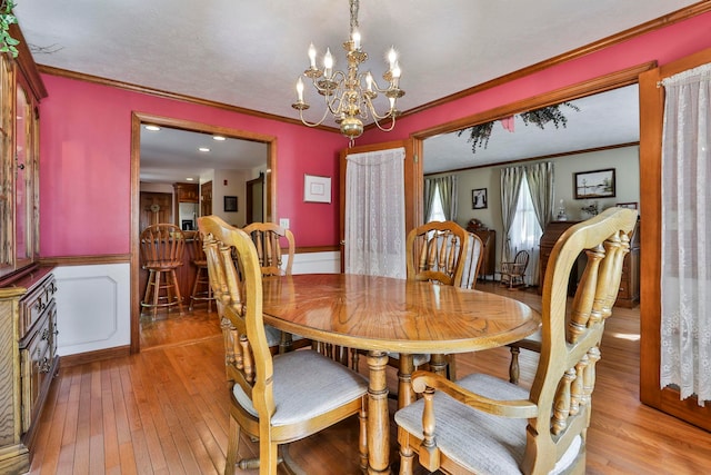 3 Elijah Hill Ln, Londonderry, NH 03053 - dining space featuring ornamental molding, light wood-style flooring, a chandelier, and wainscoting