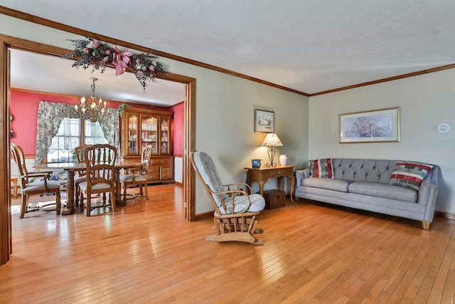 3 Elijah Hill Ln, Londonderry, NH 03053 - living room with a chandelier, light wood-style flooring, crown molding, and baseboards