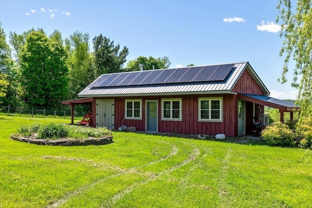 300 River Rd, Enosburg, VT 05450 - view of front facade with roof mounted solar panels, a front yard, board and batten siding, and metal roof
