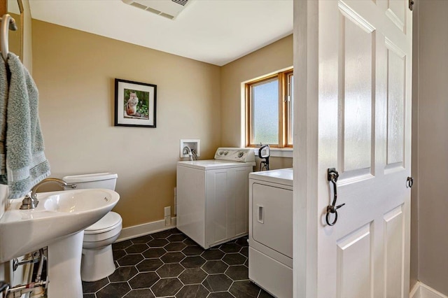 300 River Rd, Enosburg, VT 05450 - laundry room featuring washer and dryer, baseboards, and dark tile patterned flooring