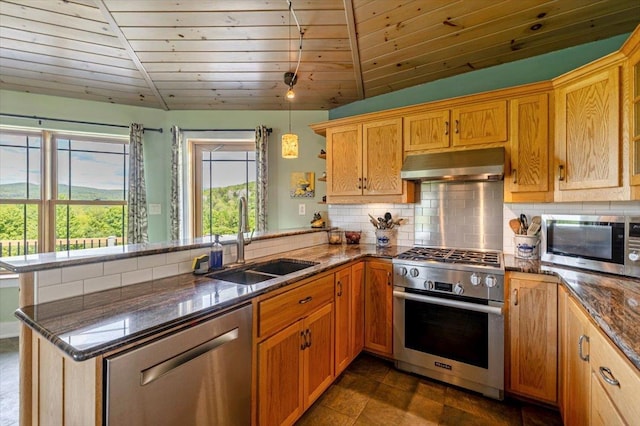 300 River Rd, Enosburg, VT 05450 - kitchen with stainless steel appliances, under cabinet range hood, a sink, a peninsula, and backsplash