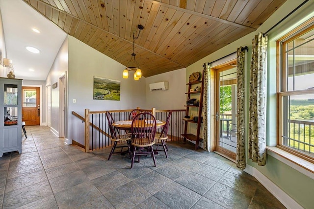 300 River Rd, Enosburg, VT 05450 - dining room featuring baseboards, a wall unit AC, vaulted ceiling, recessed lighting, and stone tile flooring