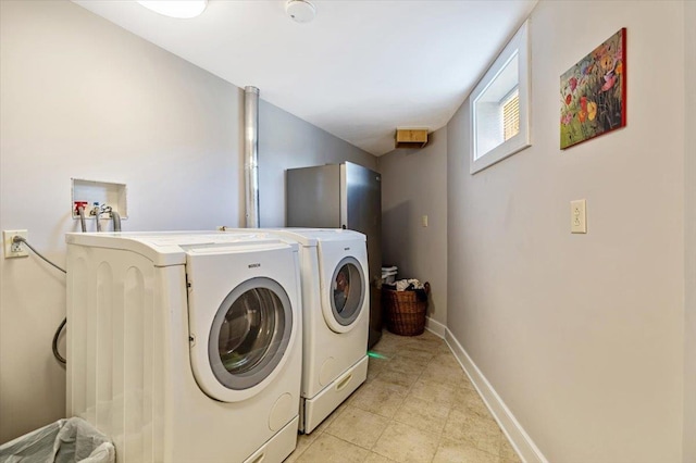 300 River Rd, Enosburg, VT 05450 - laundry area featuring washer and dryer, light tile patterned floors, and baseboards