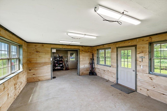 300 River Rd, Enosburg, VT 05450 - empty room with wood walls and concrete floors