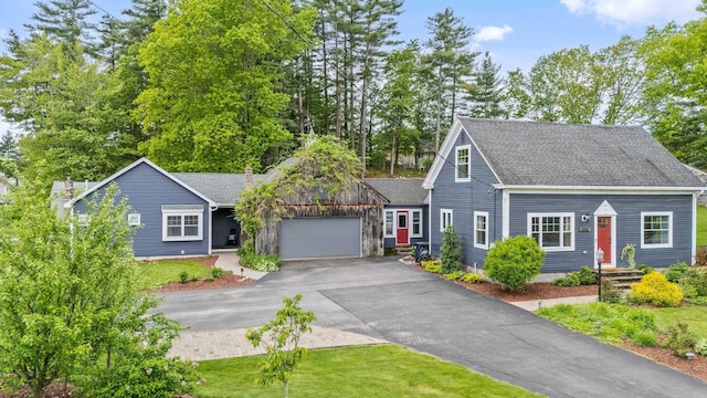 218 Manchester St, Nashua, NH 03064 - view of front of property featuring asphalt driveway, an attached garage, and roof with shingles