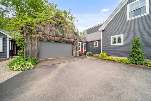 218 Manchester St, Nashua, NH 03064 - view of front facade featuring driveway and an attached garage