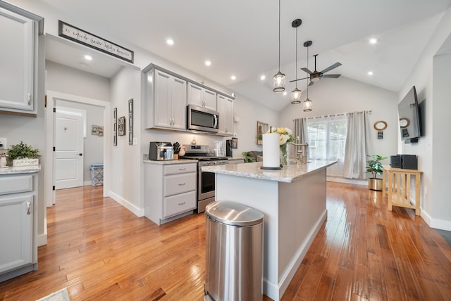 218 Manchester St, Nashua, NH 03064 - kitchen featuring stainless steel appliances, a ceiling fan, gray cabinetry, light wood finished floors, and vaulted ceiling