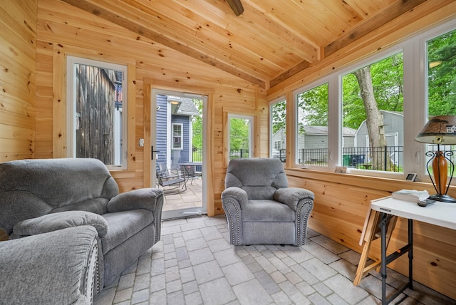 218 Manchester St, Nashua, NH 03064 - living room featuring lofted ceiling, wooden walls, and brick patterned floors