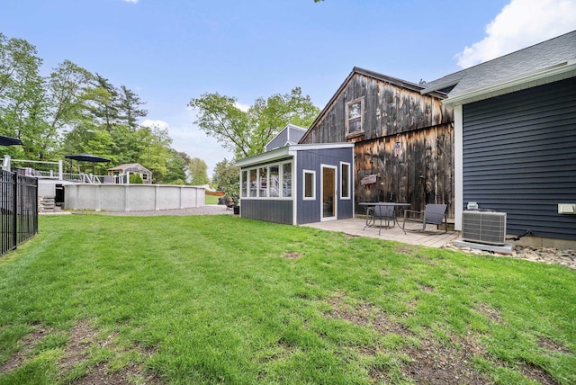 218 Manchester St, Nashua, NH 03064 - view of grassy yard featuring a patio area, a swimming pool, and cooling unit