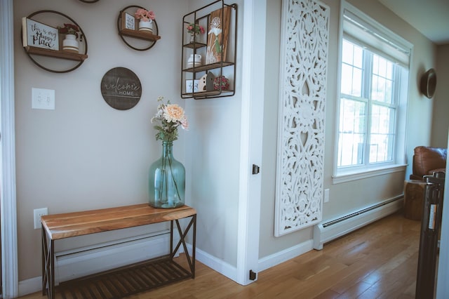 7 Plum St, Concord, NH 03301 - detailed view of a baseboard radiator, wood finished floors, and baseboards