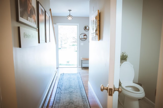 7 Plum St, Concord, NH 03301 - hallway with a baseboard radiator, baseboards, and wood finished floors