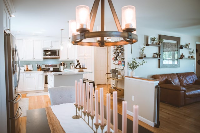 7 Plum St, Concord, NH 03301 - dining room with light wood finished floors, recessed lighting, and a chandelier