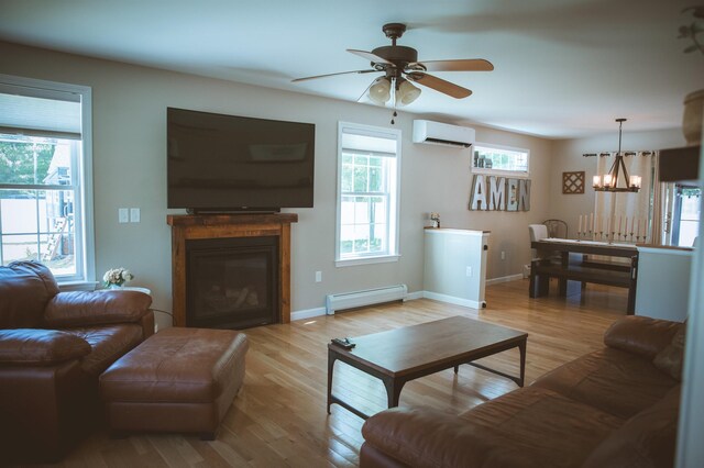 7 Plum St, Concord, NH 03301 - living area featuring a baseboard radiator, an AC wall unit, a chandelier, ceiling fan, and a glass covered fireplace