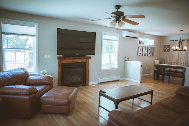 7 Plum St, Concord, NH 03301 - living area with a wall unit AC, a baseboard heating unit, ceiling fan, light wood-style floors, and a chandelier