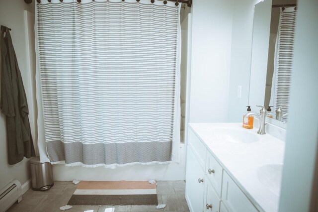 7 Plum St, Concord, NH 03301 - full bath featuring a baseboard radiator, double vanity, tile patterned floors, and shower / tub combo with curtain
