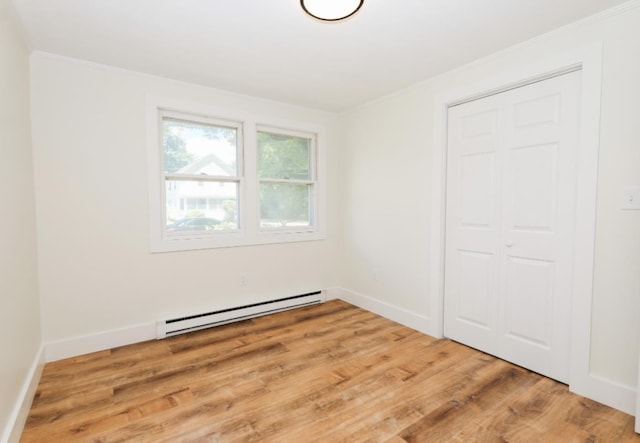 21 Hope Ave, Concord, NH 03301 - unfurnished bedroom featuring baseboard heating, wood finished floors, ornamental molding, a closet, and baseboards