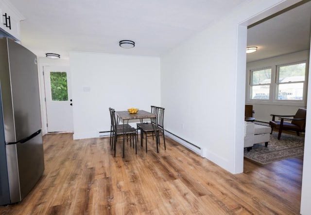 21 Hope Ave, Concord, NH 03301 - dining room with a baseboard heating unit and light wood finished floors